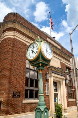 Montclair, NJ - USA -May 29, 2022 The closeup of former Montclair National Bank and Trust at the corner of Bellvue Avenue and Valley Road, Presently a Chase Bank. Old fashion Street clock in front. clipart