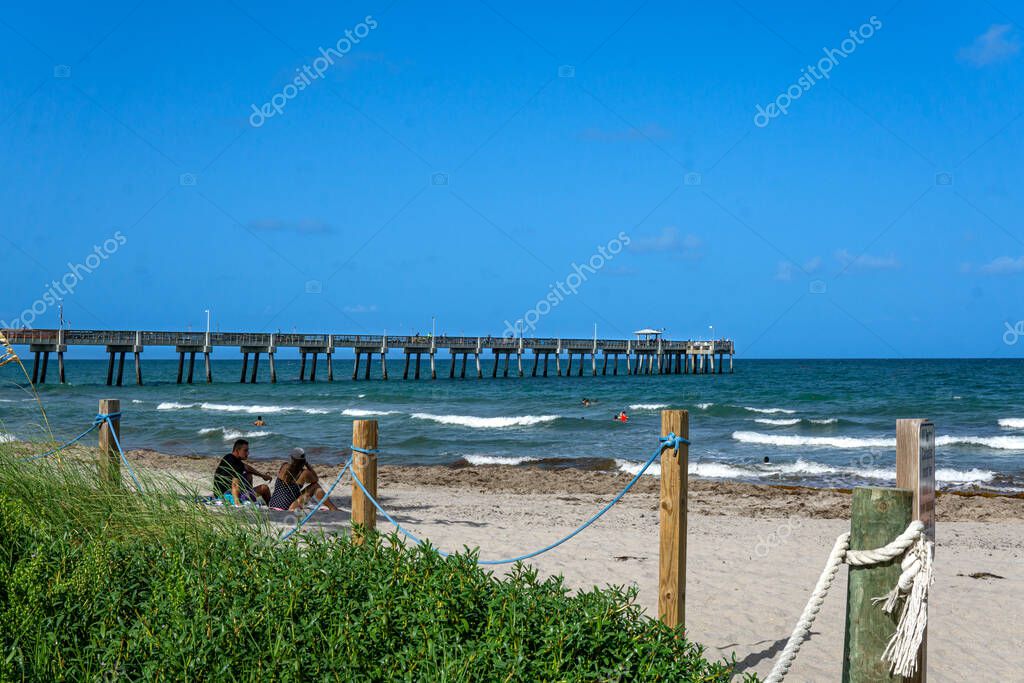 Dania Beach, FL USA July 27, 2022 Landscape view of Dania Beach Ocean Park Pier and swimmers