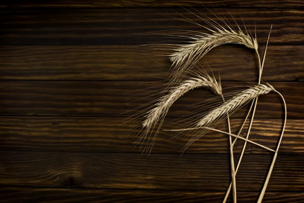 Wheat on the wood background — Stock Photo, Image