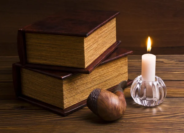 Ancient books with candle — Stock Photo, Image