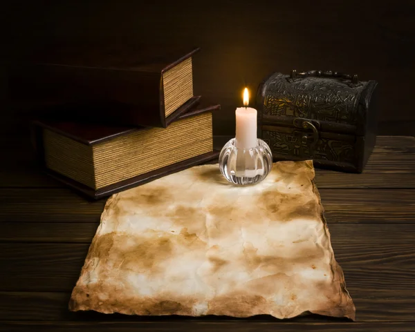 Перо, старая бумага и свеча на деревянном фоне — стоковое фото