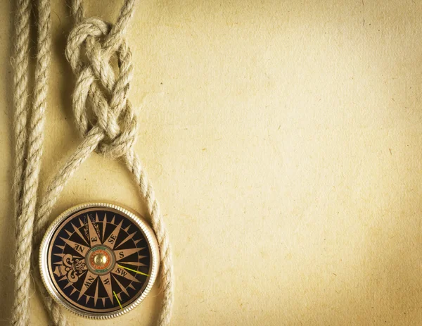 Rope and compass on the old paper background — Stock Photo, Image