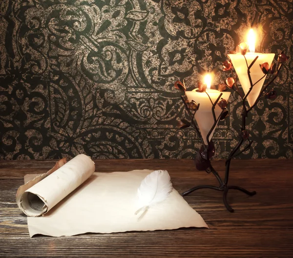 Old paper with a candle and a quill pen — Stock Photo, Image