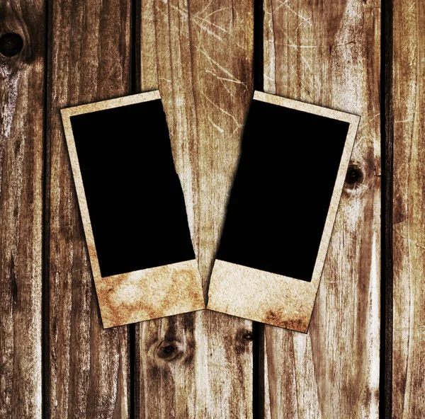 Torn picture on a wooden table — Stock Photo, Image