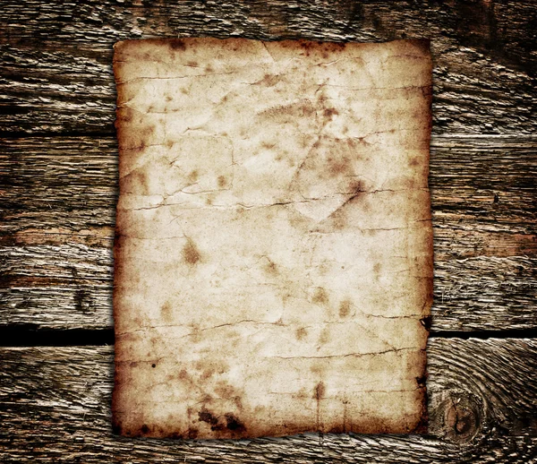 Old paper on the wood background — Stock Photo, Image