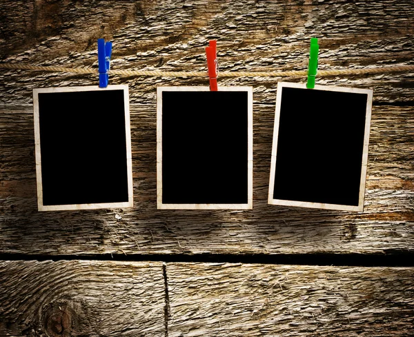 Aged photo frames on wood background — Stock Photo, Image