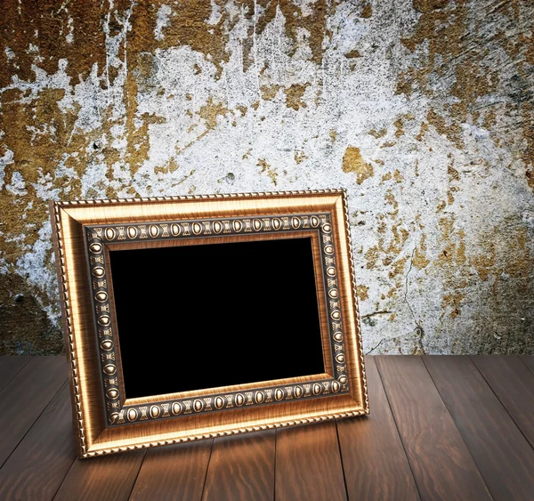 Old photo frame on the wooden table — Stock Photo, Image