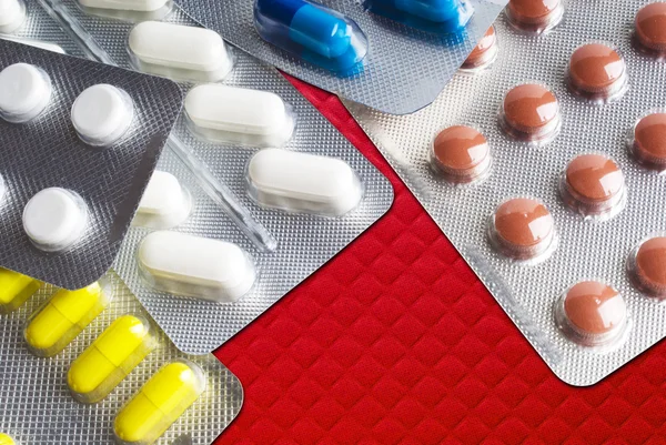 Capsules and pills packed in blisters close-up background — Stock Photo, Image