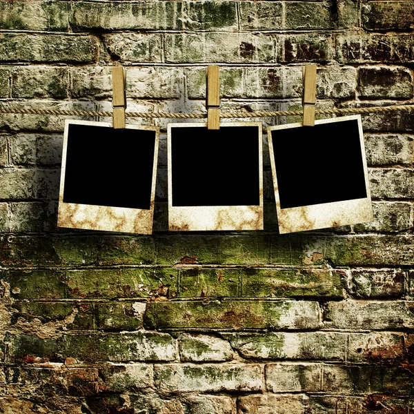 Pictures on a rope with clothespins, with clipping path for images, in front of a brick wall — Stok fotoğraf