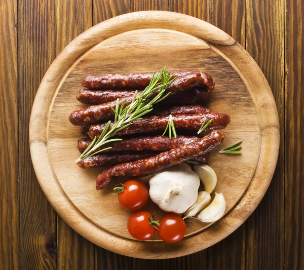 Smoked sausage with rosemary and peppercorns tomatoes and garlic — Stock Image Smoked sausage with rosemary and peppercorns tomatoes and garlic Royalty Free Stock Photos