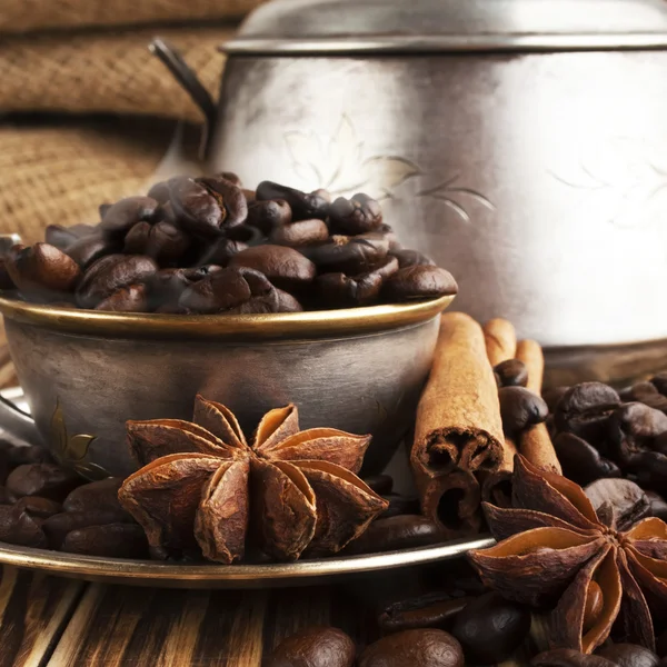 Coffee beans in a silver cup with smoke — Stock Photo, Image