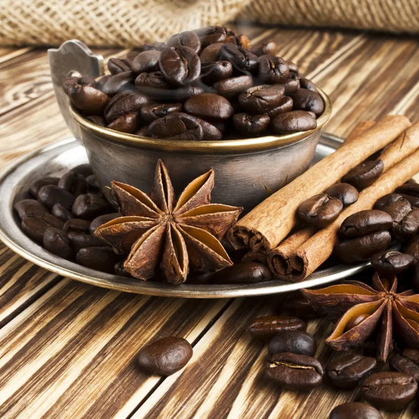 Coffee beans in a silver cup with smoke — Stock Photo, Image