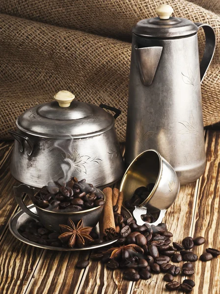 Coffee beans in a silver cup with smoke — Stock Photo, Image