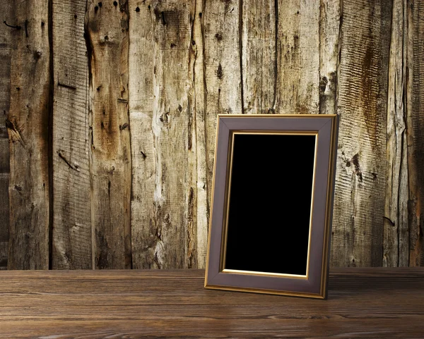 Photo frame on old wooden table — Stock Photo, Image