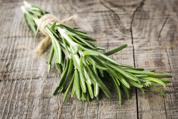 Rosemary bound on a wooden board — Stock Photo, Image