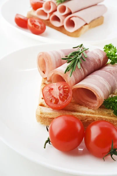 Slices of ham with rosemary — Stock Photo, Image