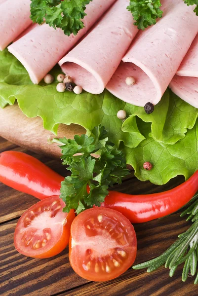 Fresh ham slices with lattuce and cherry tomato on the wooden board Royalty Free Stock Images