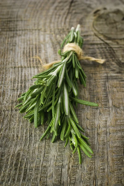 Rosemary bound on a wooden board — Stock Photo, Image