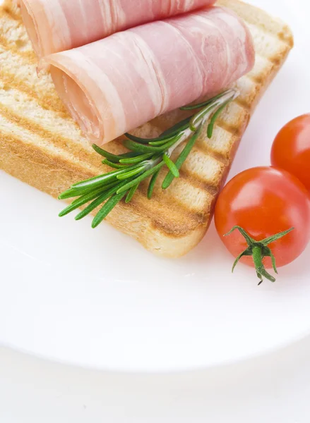 Slices of ham with rosemary — Stock Photo, Image
