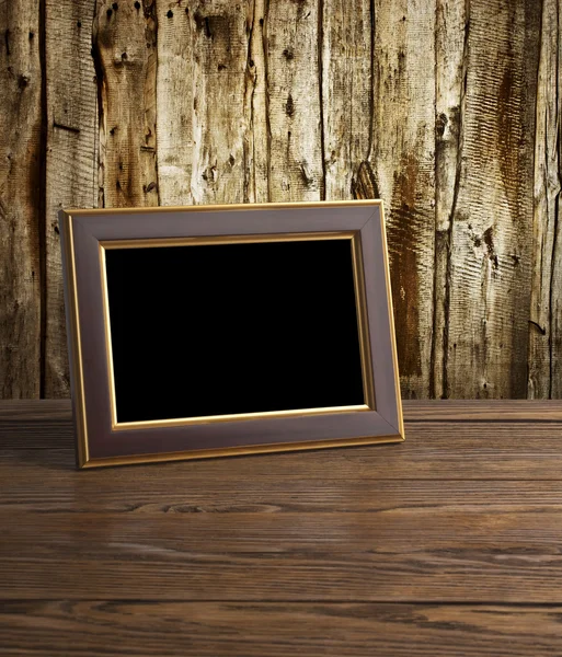 Photo frame on old wooden table — Stock Photo, Image