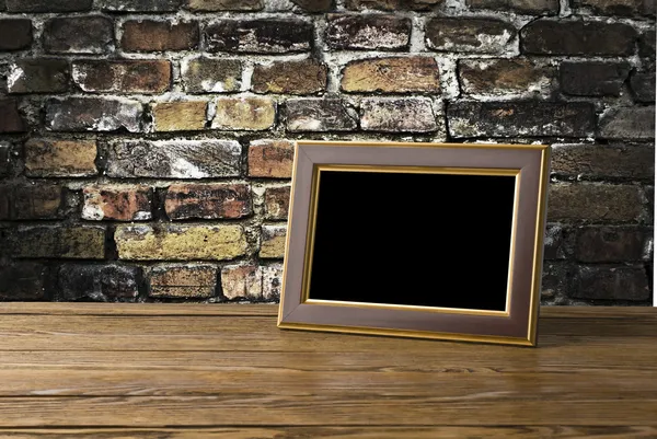 Photo frame on old wooden table — Stock Photo, Image