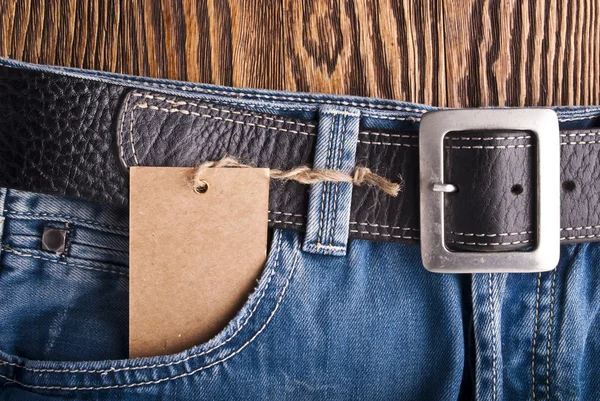 Vintage paper tag on blue denim — Stock Photo, Image