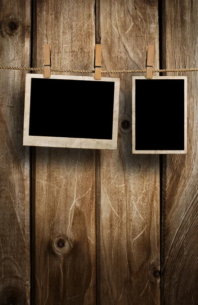 Aged photo frames on wood background — Stock Photo, Image