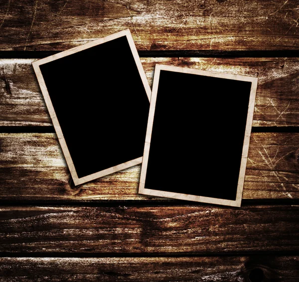 Old blank photos frames lying on a wood surface for text and photo — Stock Photo, Image