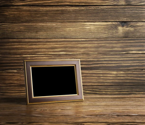 Photo frame on old wooden table — Stock Photo, Image