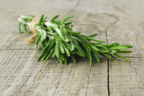 Rosemary bound on a wooden board — Stock Photo, Image
