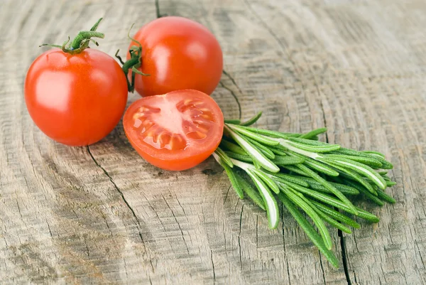 Bovenaanzicht op gesneden tomaten kersen met rozemarijn — Stockfoto