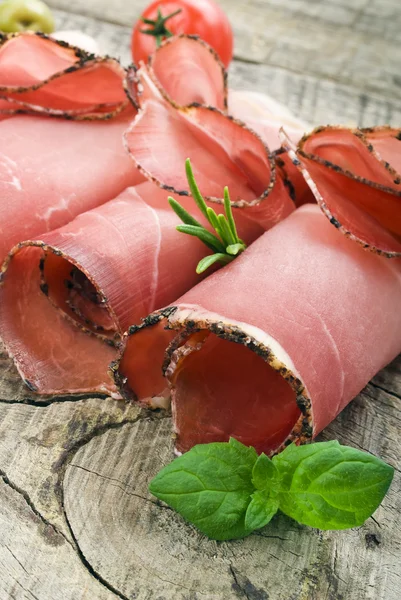 Cured ham on wooden ground — Stock Photo, Image