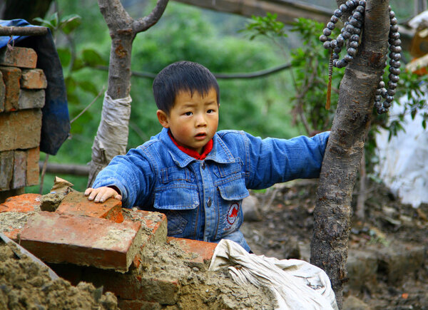 WUDANSHAN, CHINA - NOV 1, 2007: Small Asian boy at a constructio