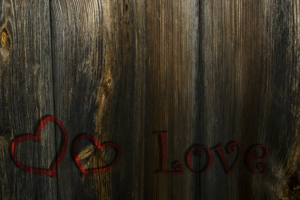 Zwei rote Herzen und die Inschrift auf dem hölzernen Hintergrund — Stockfoto