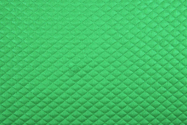 Green fabric with patterns, a background — Stock Photo, Image