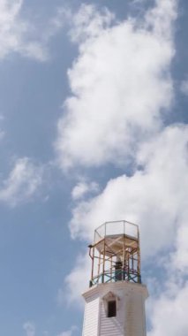 Vertical time-lapse of the old lighthouse at Isla Mujeres in Mexico against blue sky