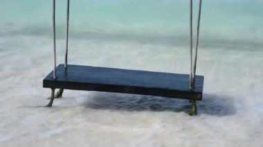 A swing on ropes in the sea on a tropical island in Mexico. A vacation at the resort. High-quality fullHD footage