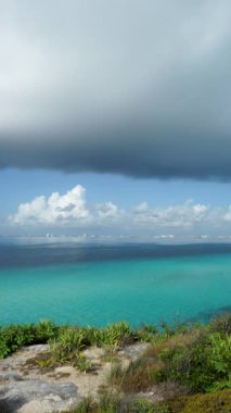 Vertical footage of a tropical island coastline with large storm clouds. The landscape of storm clouds. Isla Mujeres, Mexico