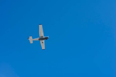 Small single-engine plane flying against blue sky. on blue, Playa del Carmen, Mexico