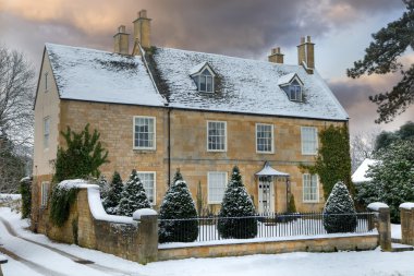Cotswold home with snow clipart