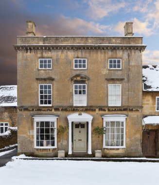 Cotswold house in snow clipart