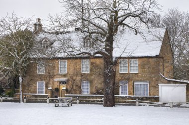 Cotswold house in winter clipart