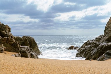 High Tides Coming on to the Rocky Shores of Costa Brava in Spain, cloudy weather