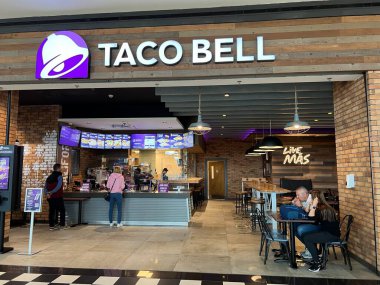 Bucharest, Romania - 05.05.2022: Taco Bell restaurant in mall food zone, visitors ordering and eating