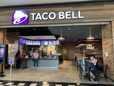 Bucharest, Romania - 05.05.2022: Taco Bell restaurant in mall food zone, visitors ordering and eating