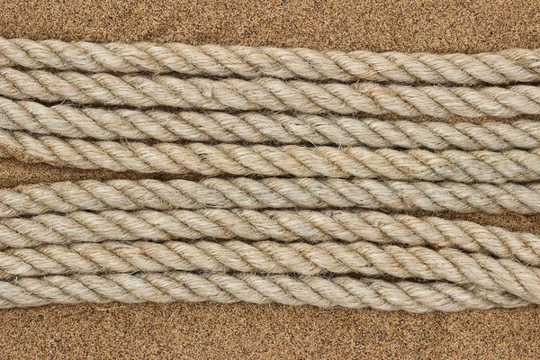 Jute rope on the sea sand — Stock Photo, Image