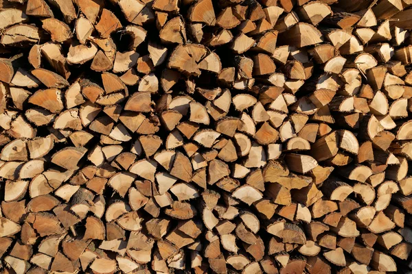 A stack of birch firewood - a natural horizontal background — Stock Photo, Image