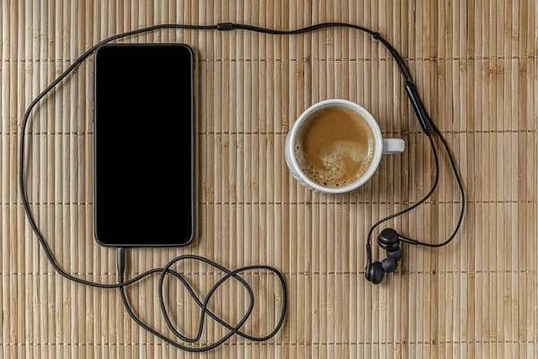 Cup Coffee Smartphone Headphones Beige Bamboo Surface Top View Mock — Stockfoto