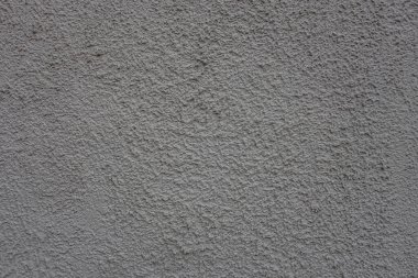 Gri kabartmalı duvarın soyut arkaplanı. Yakın plan.