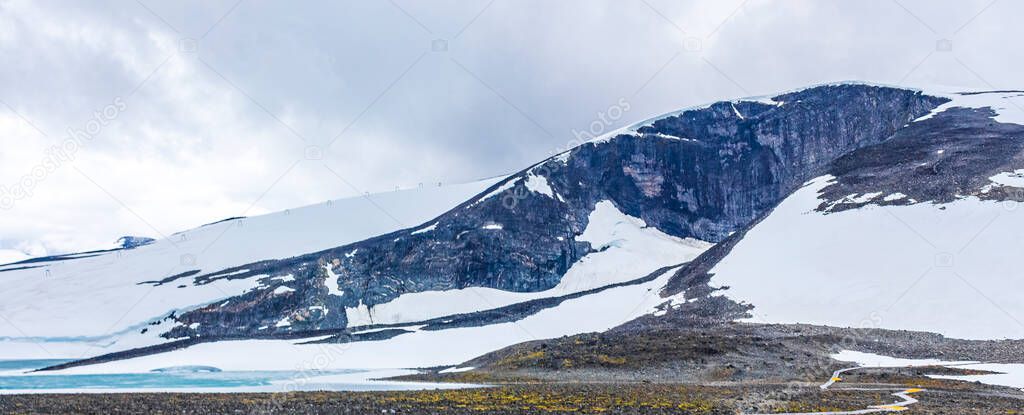 Galdhopiggen snow-covered in summer in Jotunheimen Lom in Norway is the largest and highest mountain in Norway and Scandinavia with 2469 meters.